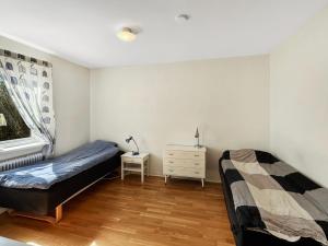 a bedroom with a bed and a table and a window at Equipped Apartments, Perfect For Workers 