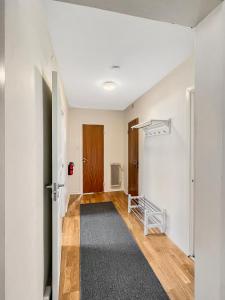 an empty room with a hallway with a door at Equipped Apartments, Perfect For Workers 