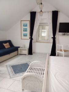 a living room with a bed and a couch at Apartment Josip in Korčula