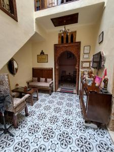 a living room with an archway with a couch and a table at Dar Si hmed in Rabat