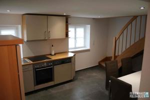 a kitchen with a sink and a stove top oven at Ferienhaus Fuldablick in Rotenburg an der Fulda