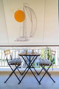 a table and two chairs in front of a window at Luxury Modern 2 bed Elegance in Athens