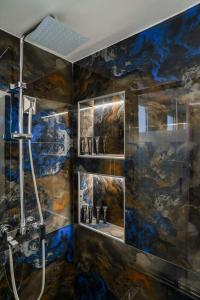 a bathroom with a shower and a painting on the wall at Luxury Modern 2 bed Elegance in Athens