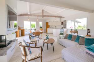 a living room with a couch and a table at Maison Madalena With Pool close to ocean 