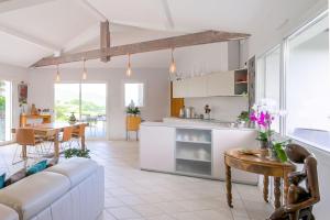a kitchen and living room with a couch and a table at Maison Madalena With Pool close to ocean 