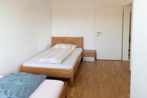 a small bedroom with two beds and a closet at Panoramablick Dobl in Dobl-Zwaring