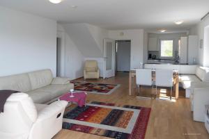 sala de estar con sofá blanco y mesa en Panoramablick Dobl, en Dobl-Zwaring