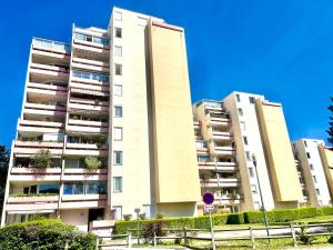 a tall apartment building in front of a blue sky at Chambre Privée en colocation dans un appartement Vaulx en Velin Centre in Vaulx-en-Velin