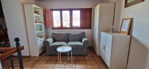 a living room with a couch and a table at Albergue Laganares - Exclusivo para peregrinos in San Nicolás del Real Camino
