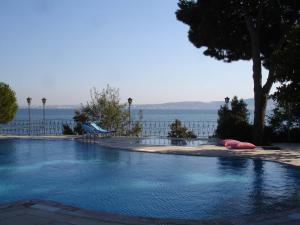 a large swimming pool with a view of the water at Kırtay Hotel Erdek in Erdek