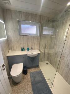 a bathroom with a toilet and a sink and a shower at Tummel View Pitlochry in Pitlochry