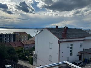 a white building with a view of the water at Apartment Piko in Crikvenica
