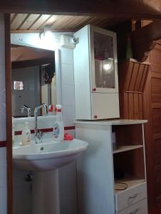 a bathroom with a sink and a microwave at Casa di Rosy in San Sperate