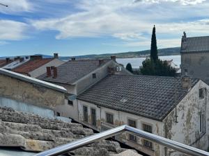 a view of roofs of buildings and a body of water at Apartment Piko in Crikvenica