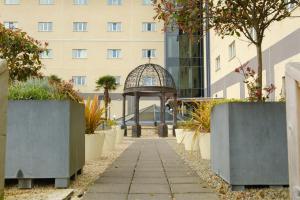 a garden with a gazebo in front of a building at Talbot Hotel Carlow in Carlow