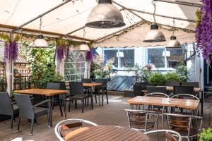 a patio with tables and chairs and purple flowers at The Beaufort Hotel in Chepstow