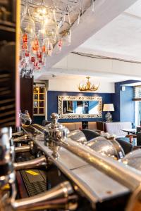 a dining room with a table with chairs and a mirror at The Beaufort Hotel in Chepstow