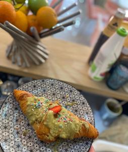 a piece of food on a plate on a table at Godard Apartments in Vlorë