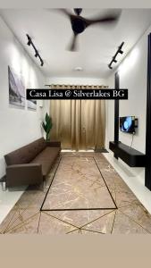 uma sala de estar com um sofá e uma ventoinha de tecto em Casa Lisa private pool @ Silverlakes BG em Batu Gajah