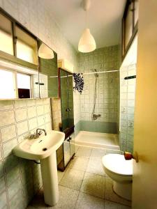 a bathroom with a sink and a toilet and a shower at Historic Malaga Centro Rooms in Málaga