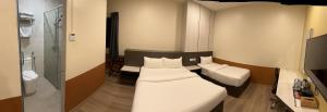 Rúm í herbergi á T SQUARE HOTEL (IPOH)