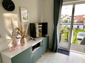 a living room with a tv on a cabinet with a tv at Apartment Kirschti in Salzwedel