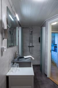 a bathroom with a sink and a shower at Breviken Golf & Hotell in Brevik