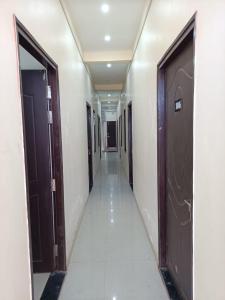 a hallway of a building with two doors at Hotel JP Inn in Lucknow