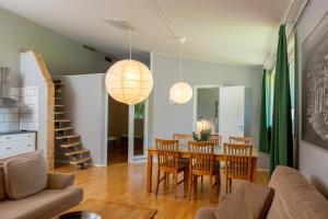 a living room with a dining room table and chairs at Breviken Golf & Hotell in Brevik