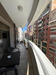 a balcony with a table and chairs on a building at Erdis Home Nr 2 in Tirana