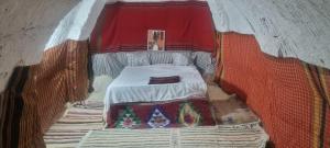 a small room with a bed in a tent at Maison d'hôte dar massouada in Tūjān