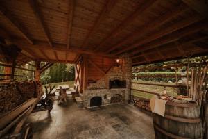 a large room with a stone fireplace in a house at Sweet Retreat in Trebelno