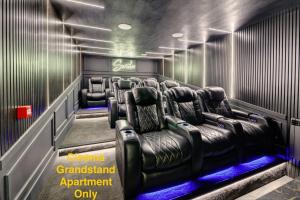 a cinema room with leather chairs and a sign that says cinema grandstand appointment only at Swish Luxury Holiday Apartments in Blackpool