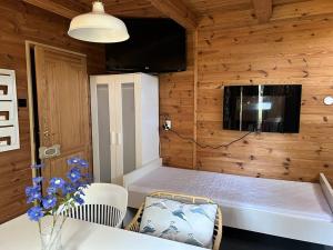 a room with a bed in a wooden wall at Ustka- Wakacyjny Domek Letni Wiatr in Ustka