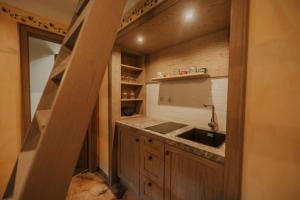 a small kitchen with a sink and a staircase at Sweet Retreat in Trebelno +24 photos