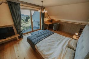 a bedroom with a large bed and a large window at Sweet Retreat in Trebelno