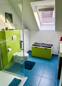 a bathroom with a toilet and a glass shower at Apartment Kirschti in Salzwedel