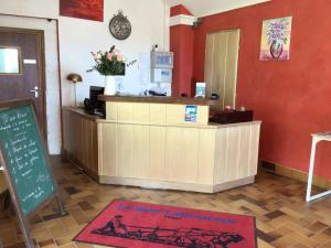 a restaurant with a cash register and a counter at Hotel Le Bon Laboureur in La Charit&eacute;-sur-Loire