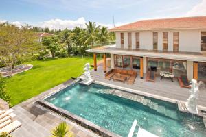 a house with a swimming pool in front of a house at Astana Villa Non Nuoc Beach in Da Nang