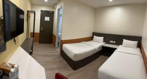 Rúm í herbergi á T SQUARE HOTEL (IPOH)