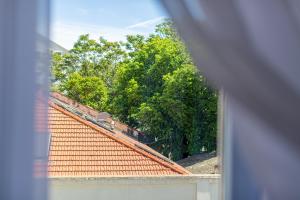 a view of a roof of a house with trees at Apartment Satureja Montana in Split