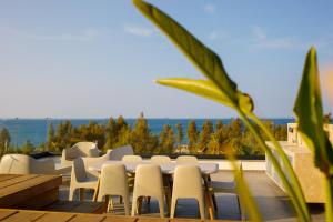 a table and chairs on a patio with a view at Sunrise Beachfront Villas - Villa 1 in Paralimni
