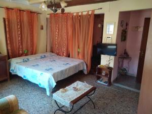 イグレージアスにあるL'Antica Locandaのベッドルーム(ベッド1台、テレビ、テーブル付)