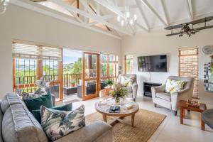 a living room with a couch and a table at Luxury , space and views - Pezula Villa 13 in Knysna