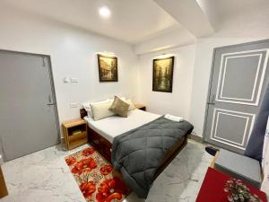 małą sypialnię z łóżkiem i drzwiami w obiekcie Ga-Ki-Khim Homestay w mieście Gangtok