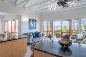 a kitchen and living room with a table at Luxury , space and views - Pezula Villa 13 in Knysna