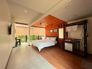 a bedroom with a white bed and a window at Hailin Resort Vangvieng in Vang Vieng