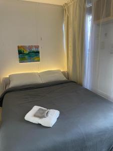 Una toalla blanca en una cama en un dormitorio en Fawlty Towers in Williamsburg en Brooklyn