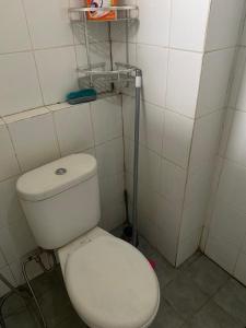 a bathroom with a white toilet in a room at OYO 93952 Dms Property in Bekasi