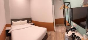 Tempat tidur dalam kamar di T SQUARE HOTEL (IPOH)